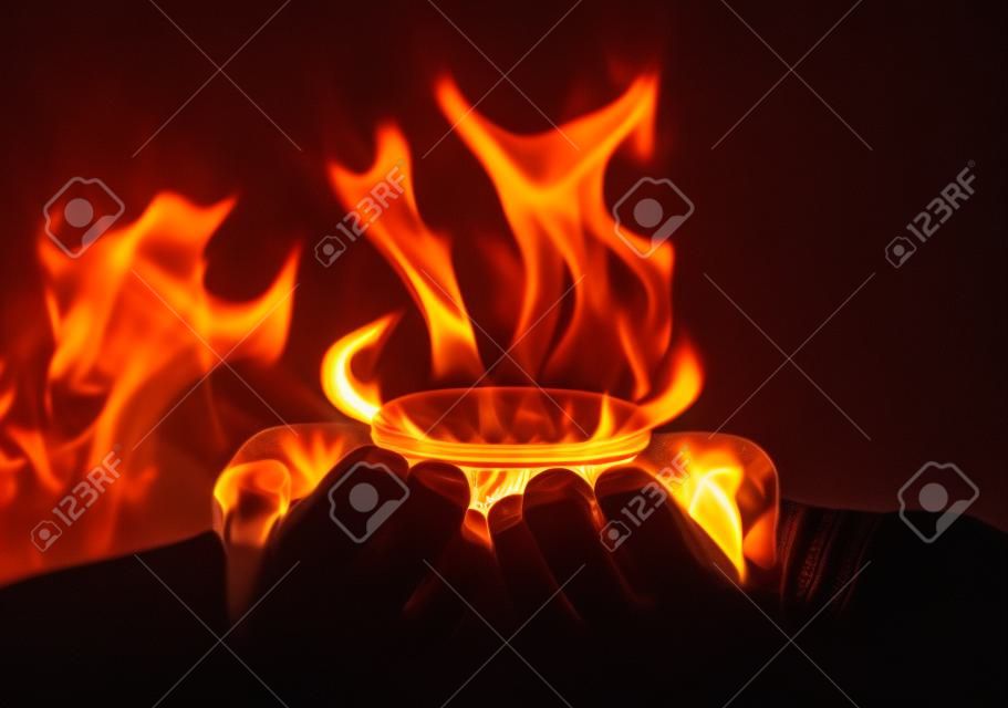 Hands holding a flame gas