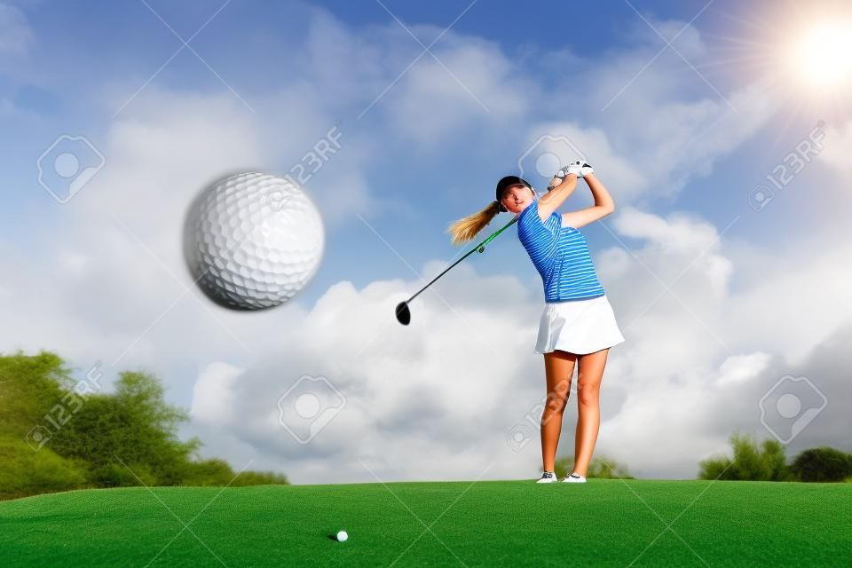 Golf ball just coming off the tee from girl golfer in swing in the morning time
