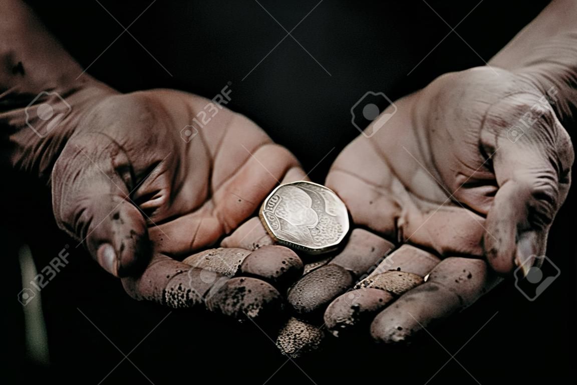 Concept Devaluation of ruble. Dirty hands old man poor with coin