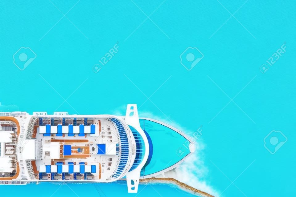 Cruise liner luxury ship in berth in port, blue sea water. Top aerial view.