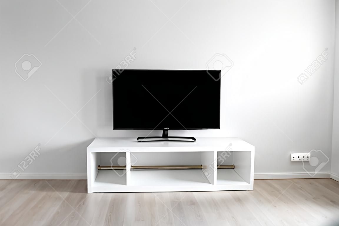 Lcd tv on white shef at modern room interior with nobody