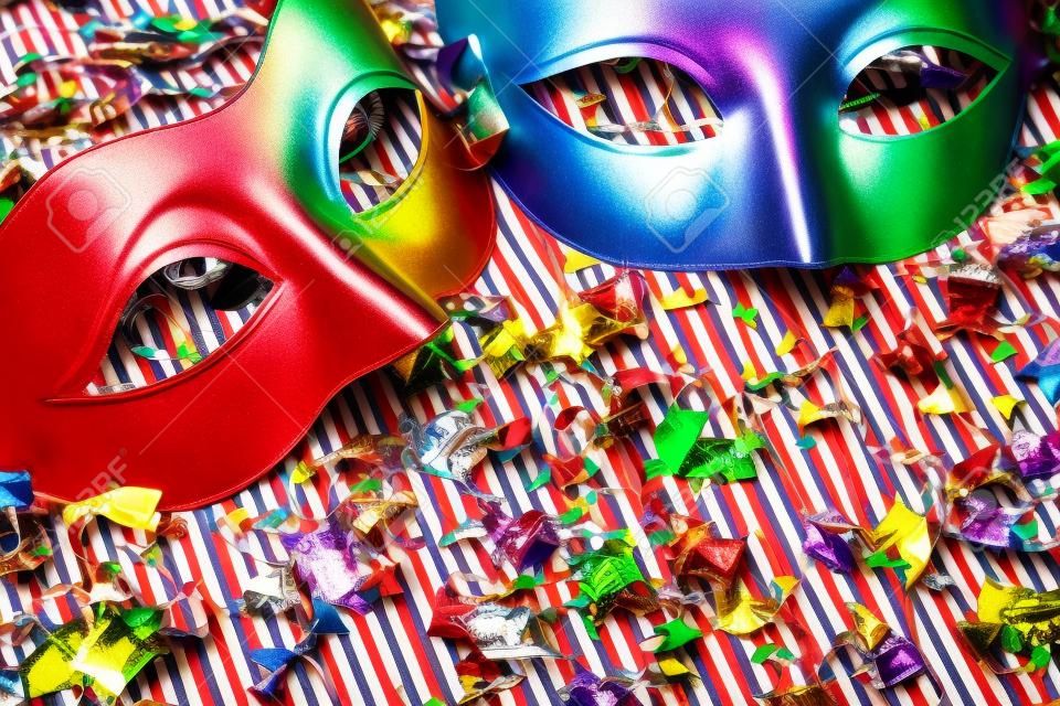 two colorful carnival masks on the colorful background with several ornaments