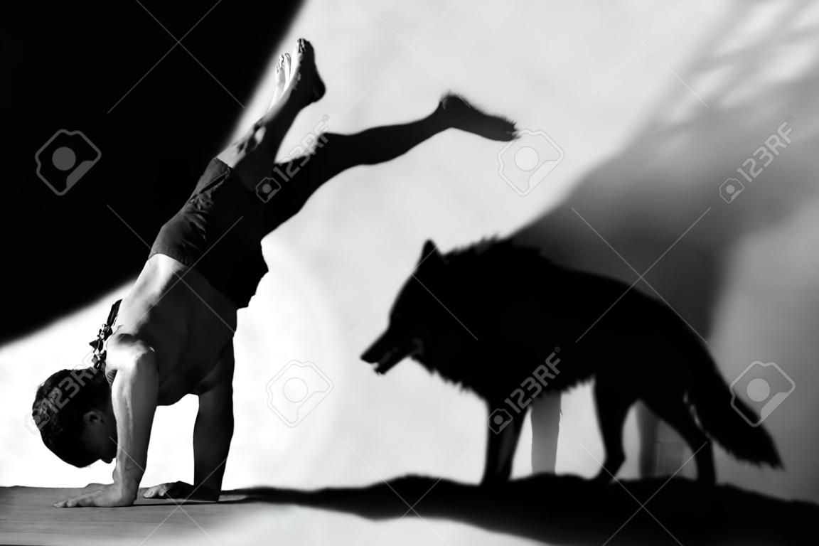 Photomanipulation  handstand in studio with wolf shadow
