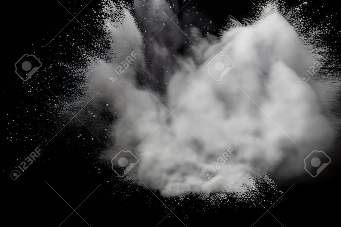 White powder dust particles explosion on a black background.