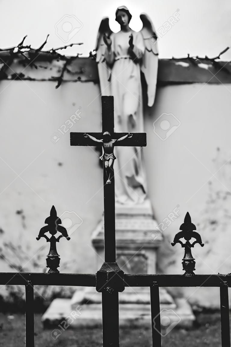 Cross and angel on cemetery