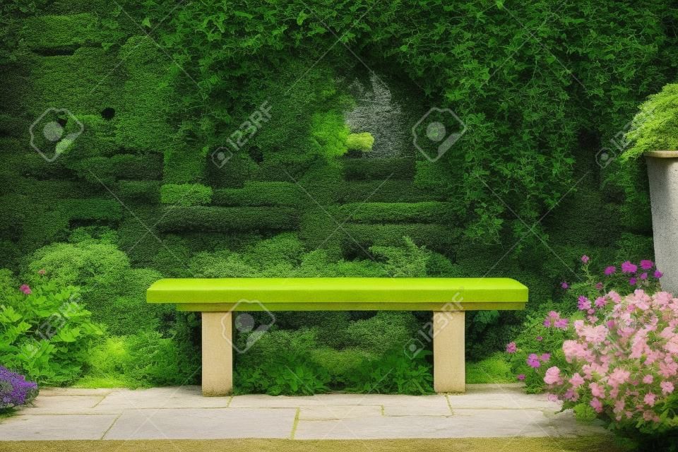 Bench in a formal garden with an old stone wall