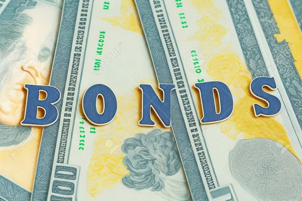 Word bonds at wooden letters on US Dollar bills