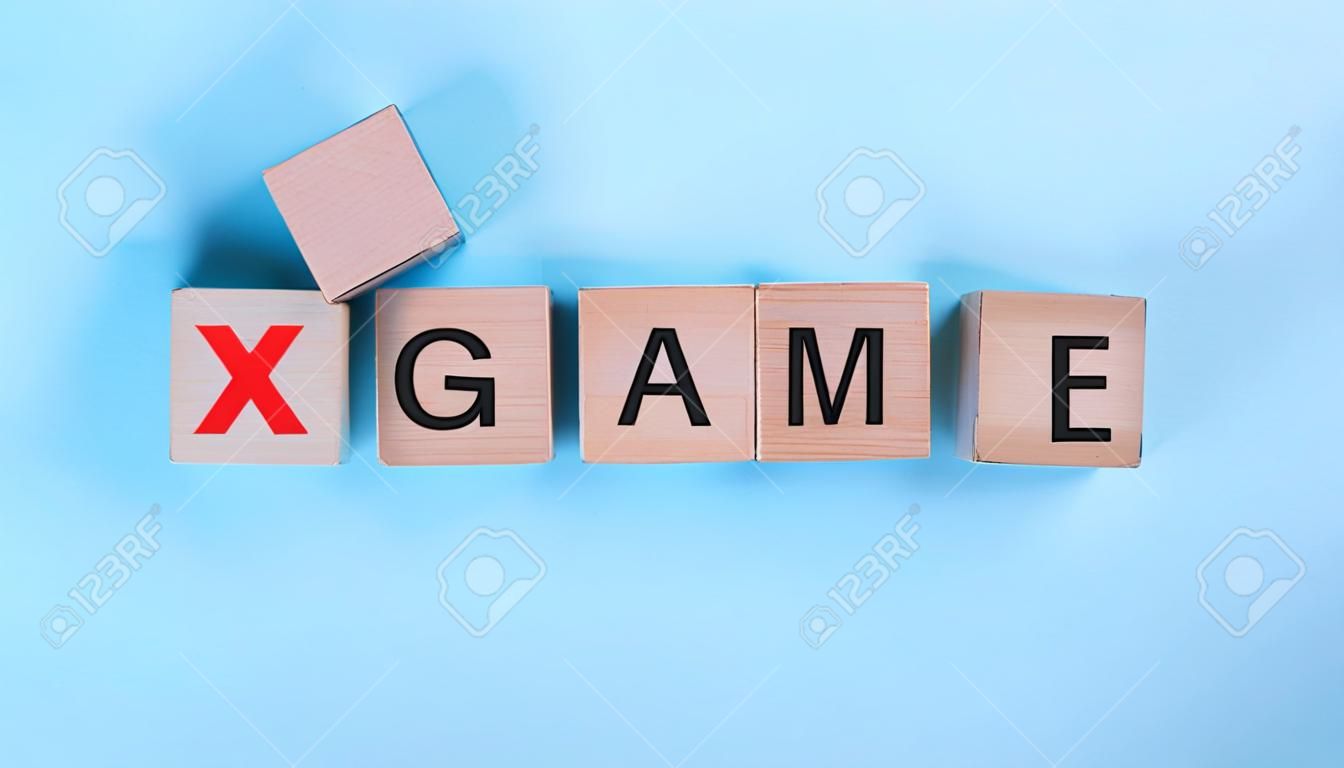 Game word wooden cubes on wooden background, mock up, template, banner with copy space for text