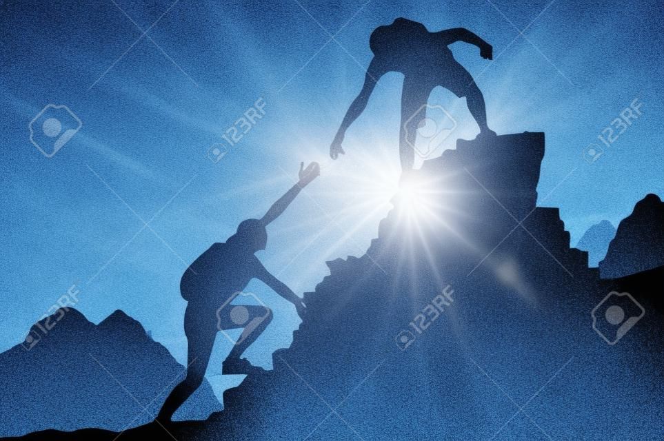 Help and assistance concept. Silhouettes of two people climbing on mountain thanks to mutual assistance and teamwork and partnership. business success and teamwork concept
