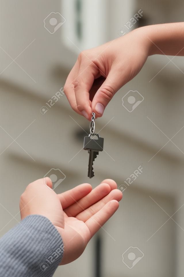 Handing Over the Key in front of new home