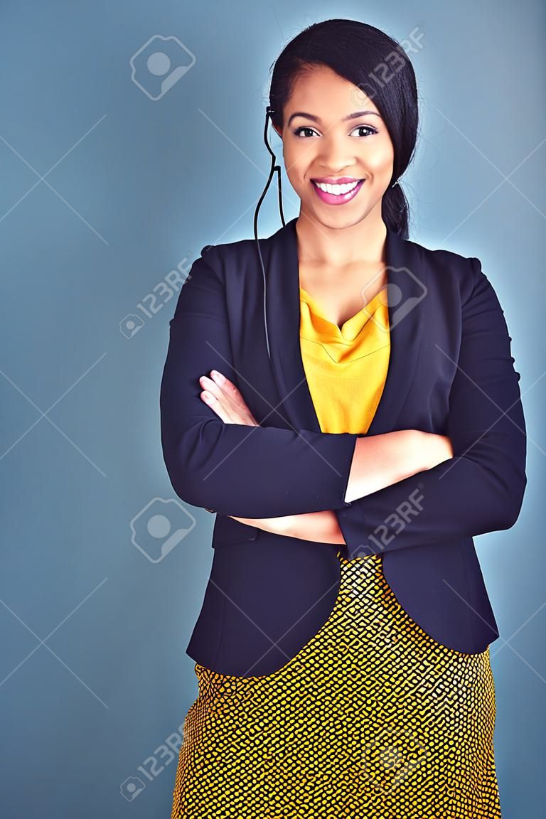 Confidence is the key to success. Studio portrait of an attractive young businesswoman standing against a blue background.