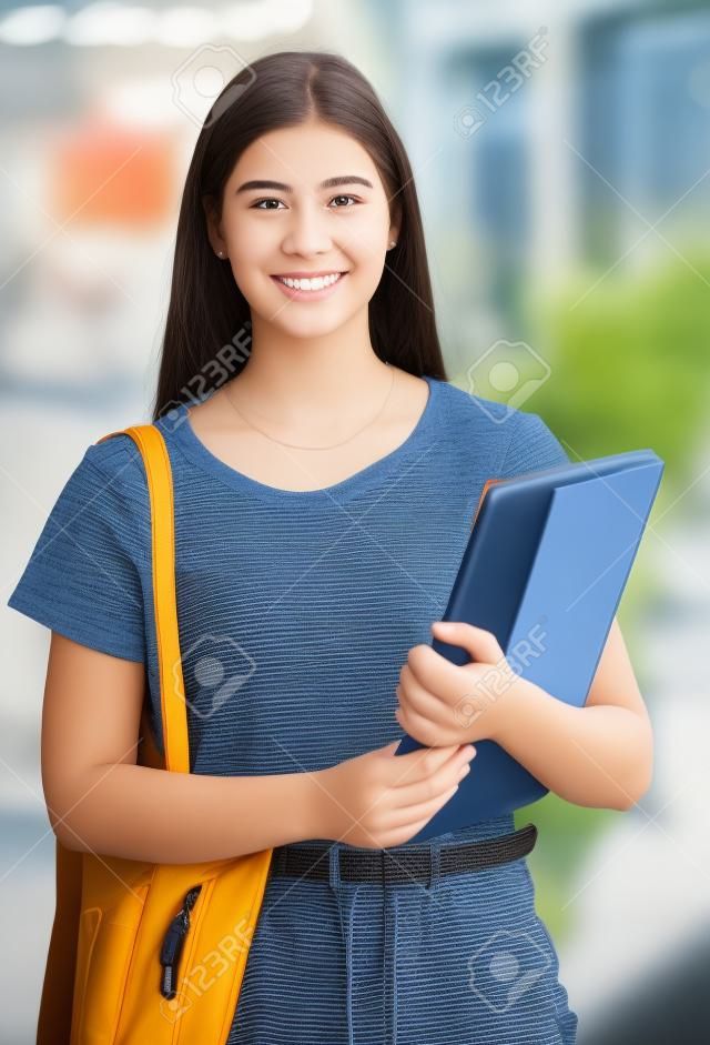 Young woman, college student portrait and university campus for learning, school studying and higher education knowledge in Canada. Happy, proud and motivation of gen z youth portrait with notebooks