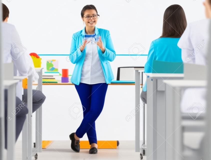 Classroom, presentation and science professor at university of physics or dna model in education, learning and teaching on whiteboard. Students in desk, teacher, leader or presenter woman in college