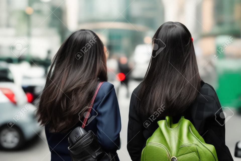 The two travelling peas in a pod. Rearview shot of two unrecognizable female friends sight seeing in the city.