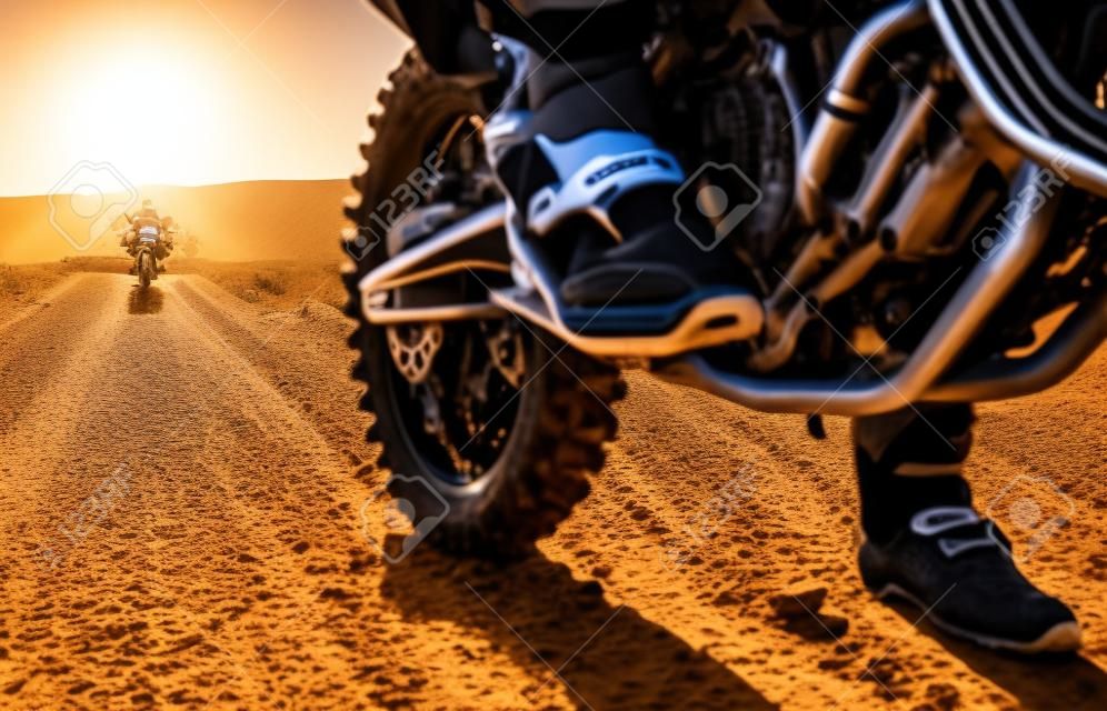 Dirt road, competition and man feet on motorcycle in desert for exercise, training or rally. Offroad, fitness and male athlete or biker riding on motorbike for action, adventure and extreme sports.