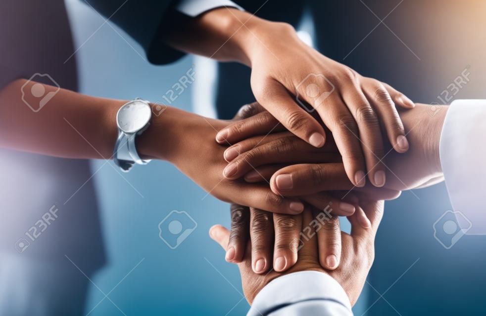 One dedicated team working towards their dream. Closeup shot of a group of unrecognizable businesspeople joining their hands together in a huddle.