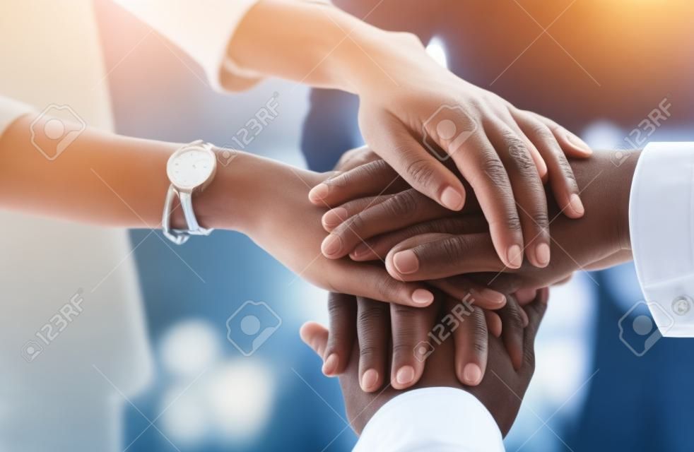 One dedicated team working towards their dream. Closeup shot of a group of unrecognizable businesspeople joining their hands together in a huddle.