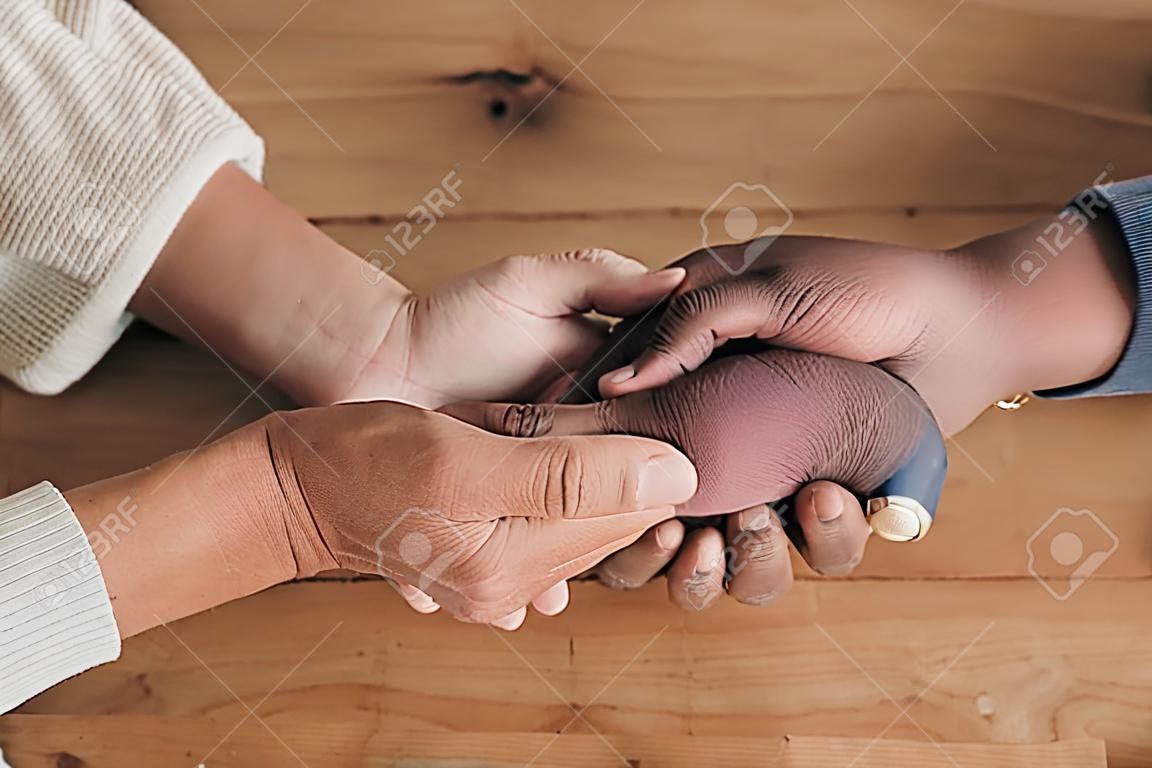 Closeup of couple holding hands for support, empathy and help with news, depression or mental health problem. Therapy, psychology and depressed, sad or anxiety of mature man and woman hand together