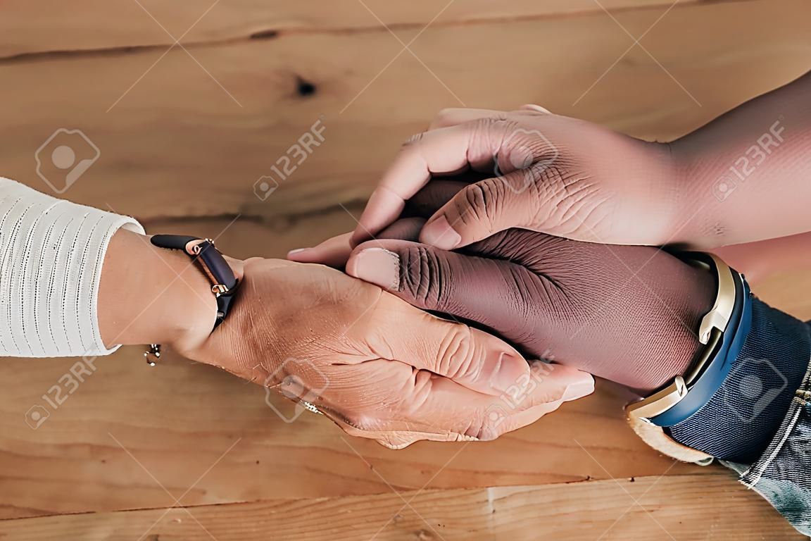 Closeup of couple holding hands for support, empathy and help with news, depression or mental health problem. Therapy, psychology and depressed, sad or anxiety of mature man and woman hand together