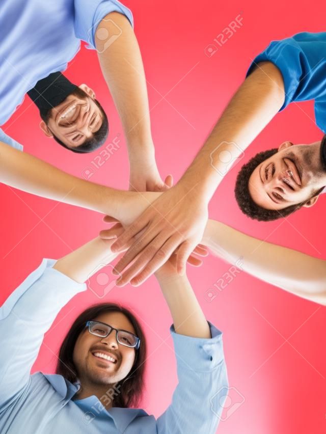 Portrait, low angle and happy people with hand huddle in support, faq and target of success, business goals or trust. Motivation, hands and group collaboration of teamwork, synergy and victory circle