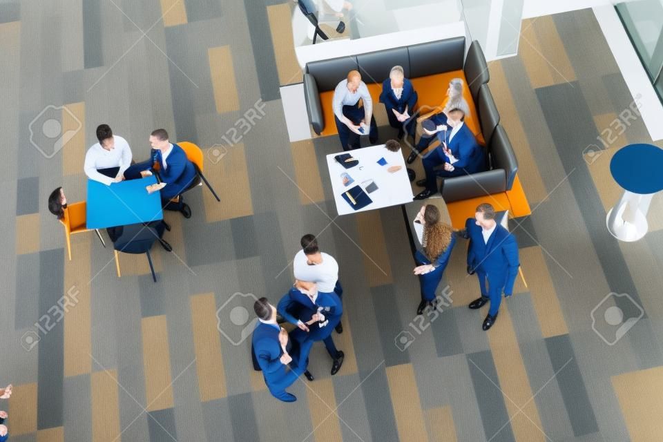 Where the movers and shakers meet up. High angle shot of a group of businesspeople having a meeting at a conference.