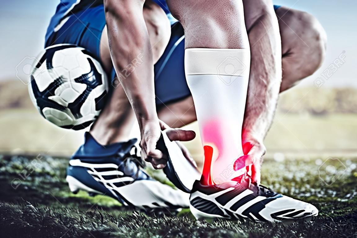 Injury, sports and hand of a man on foot pain, soccer emergency and accident while training. Fitness, problem and an athlete or football player with inflammation or a swollen muscle on the field