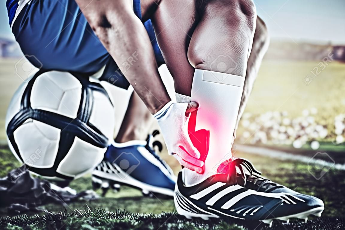 Injury, sports and hand of a man on foot pain, soccer emergency and accident while training. Fitness, problem and an athlete or football player with inflammation or a swollen muscle on the field