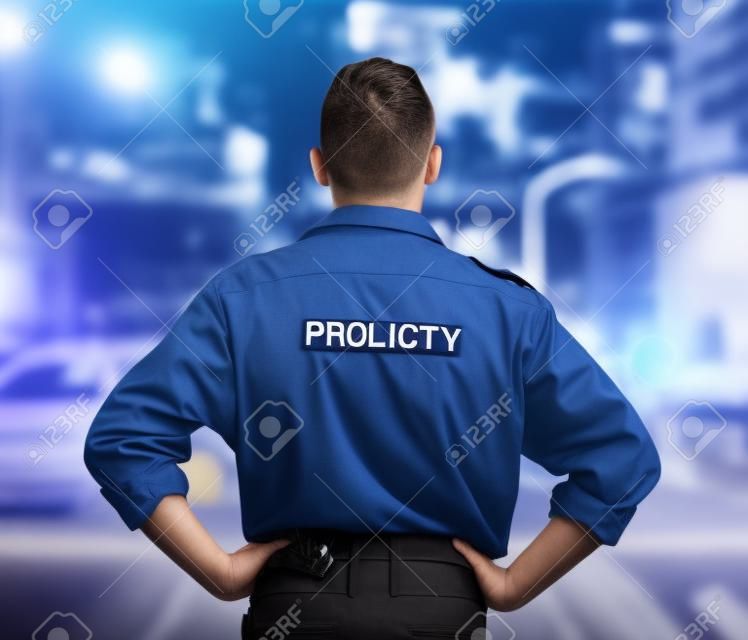 Man, back and security guard in city for safety protection, law enforcement or outdoor emergency. Rear view of male person, police or officer standing ready for crime control to protect and serve