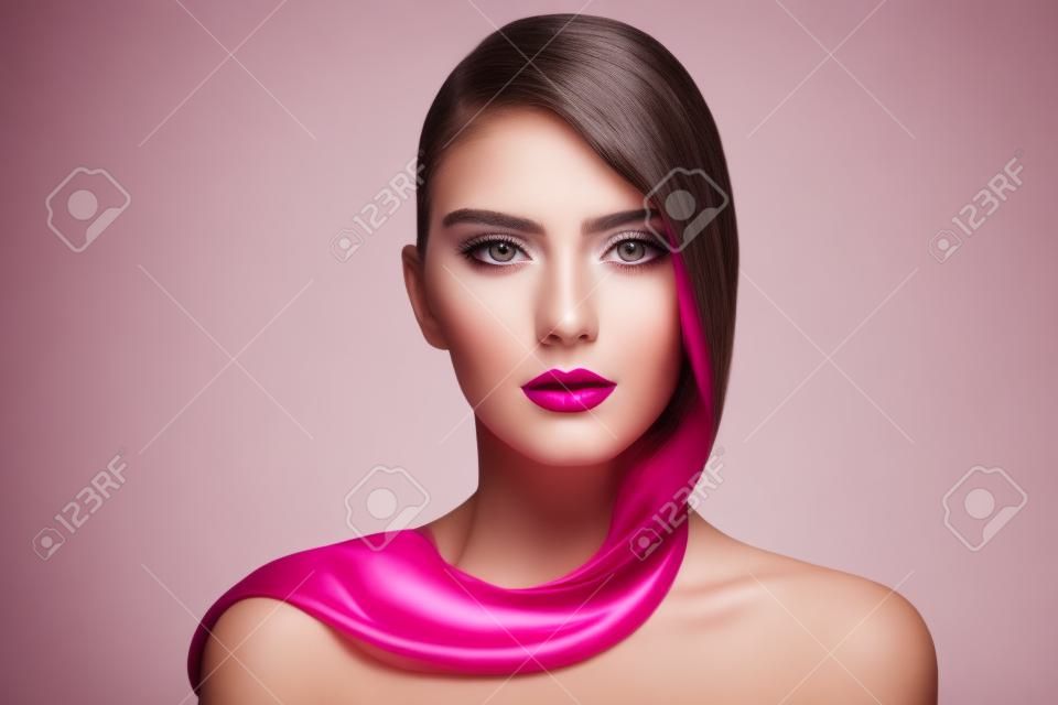 Portrait of young beautiful girl with long hair and fuchsia lipstick over white background, copy space