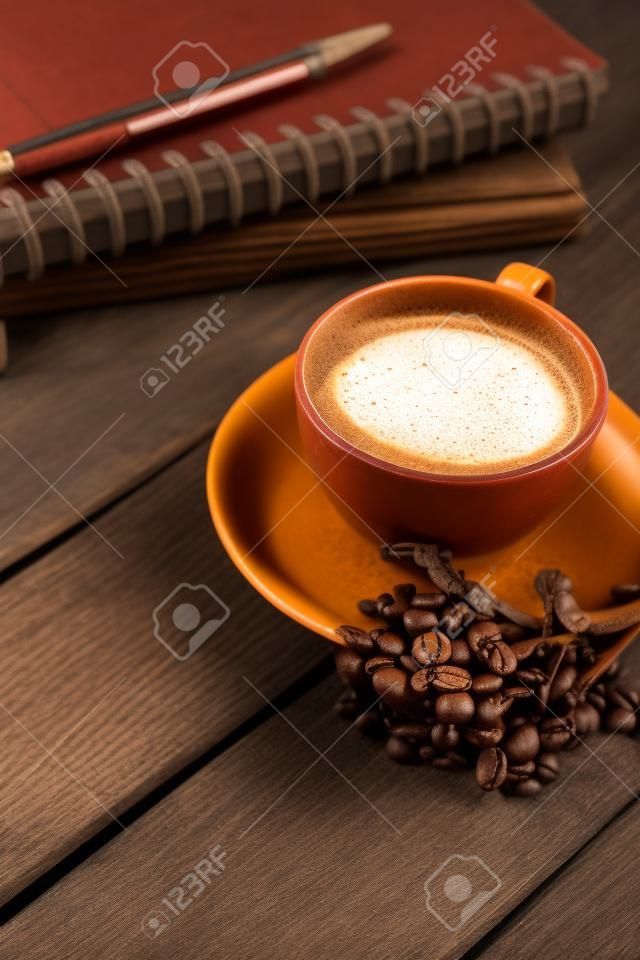 Chill and Relax with Hot Coffee and Note Book on old  wooden in vintage color tone, used for food ad or website promote. beverage for people to work place