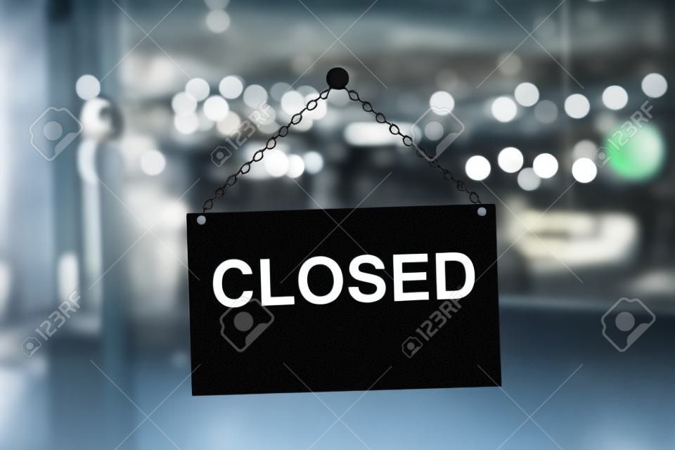 Close up of black closed sign hanging on glass door. Blurry background. Working hours concept. 3D Rendering