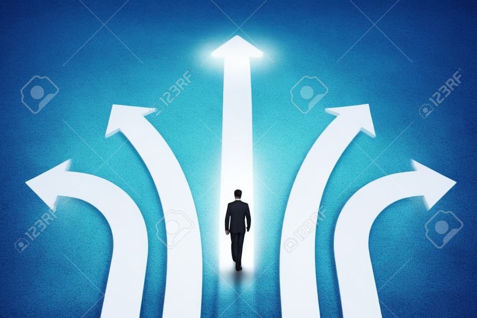Businessman walking on abstract white and glowing arrows on concrete background. Different direction and success concept.