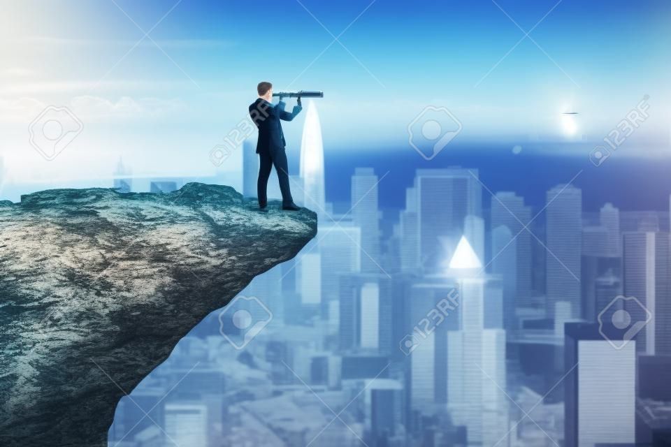 Attractive young european male with telescope on cliff edge looking into the distance on bright city background with daylight and mock up place. Future, success, leadership and career growth concept