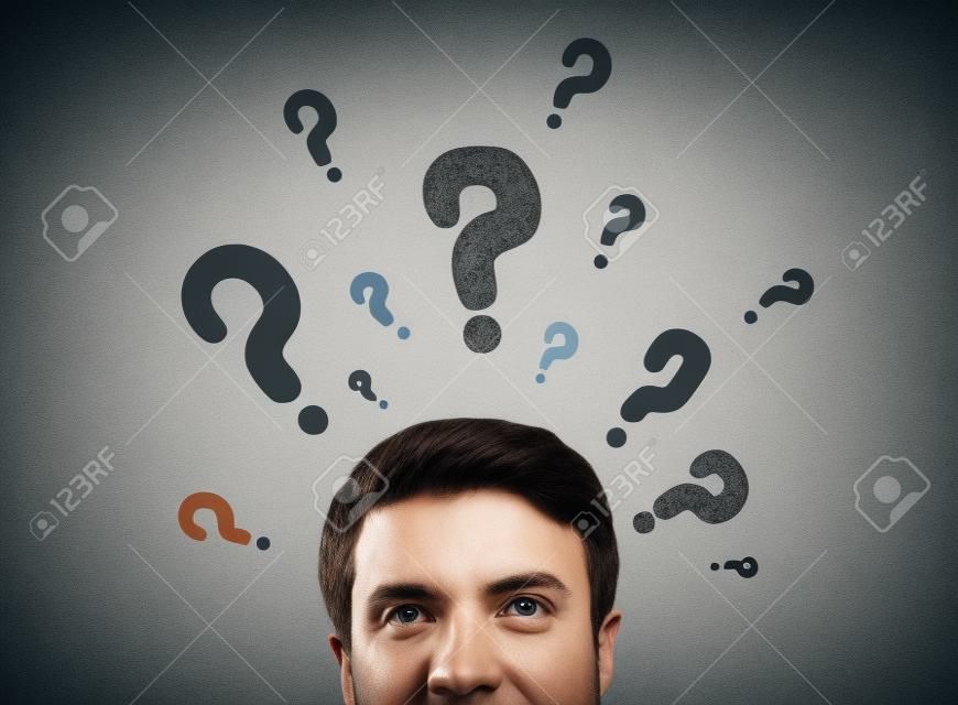 man with questions symbol on gray background