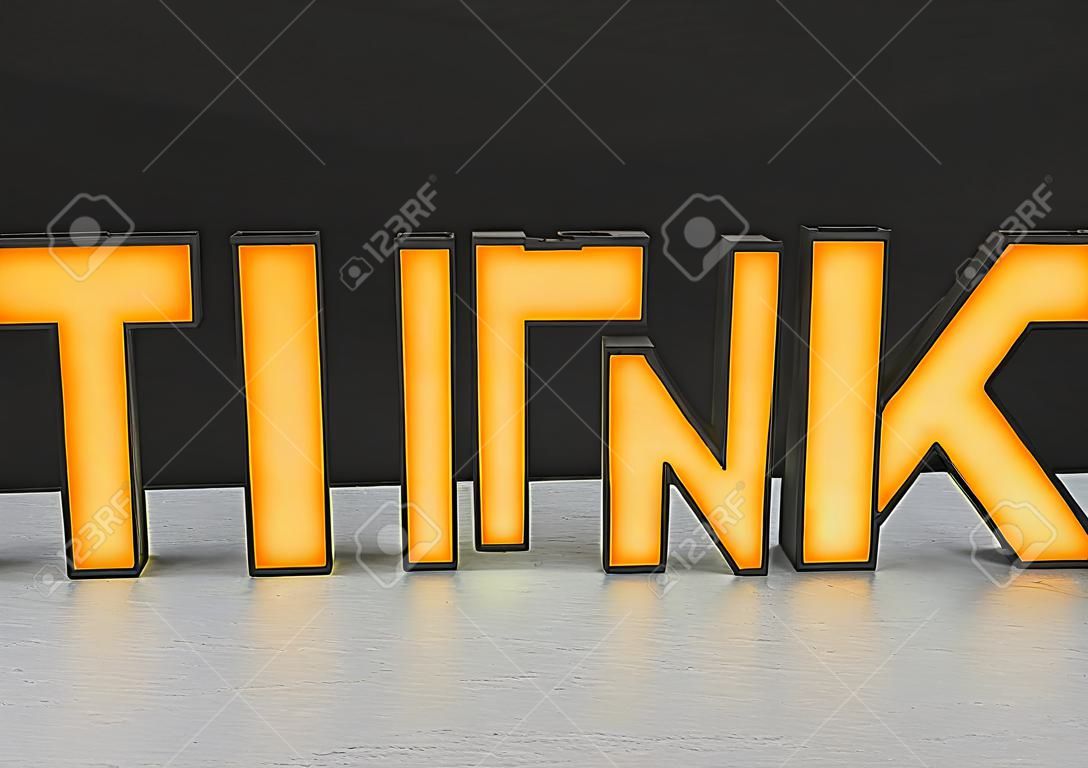 orange think glowing letters, close up
