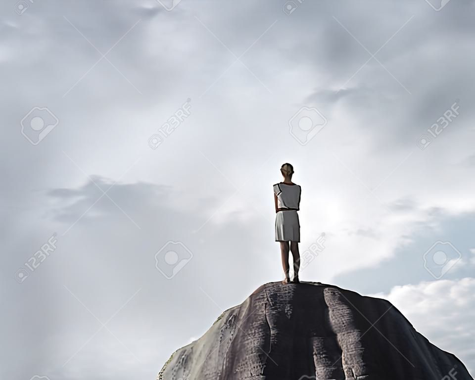 beautiful woman standing on rock