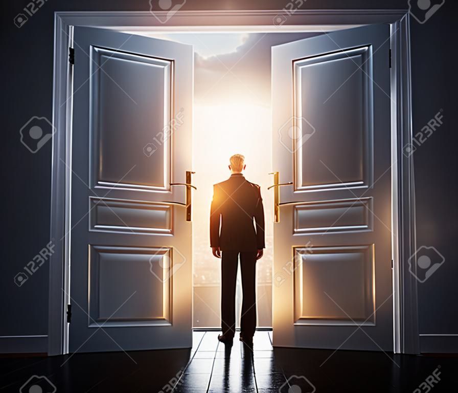 businessman in room with big open door