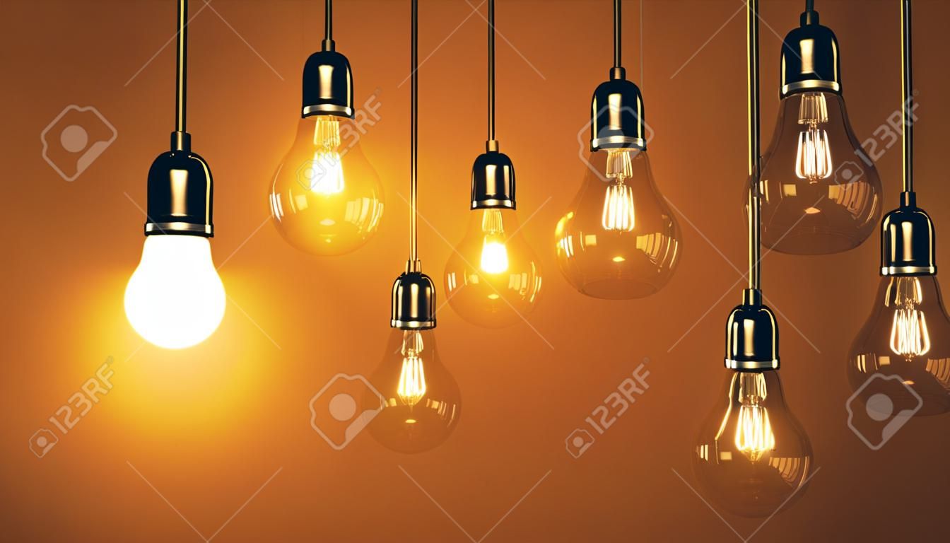 lâmpadas que penduram o fio e um brilha. Conceito da ideia do negócio.