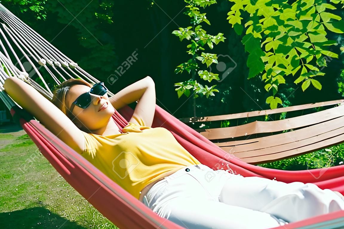 young pretty woman rest in hammock