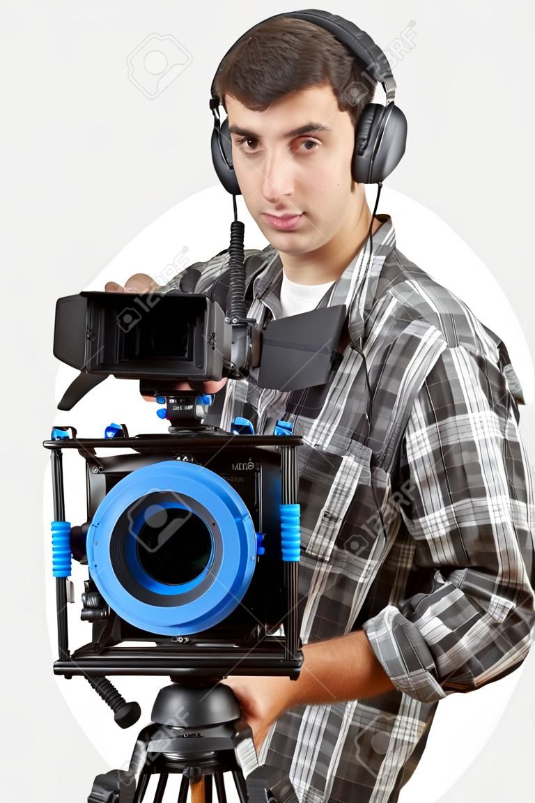 young professional cameraman and camera on the white background