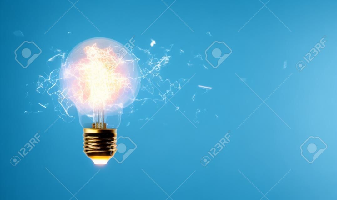 Exploding light bulb on a blue background