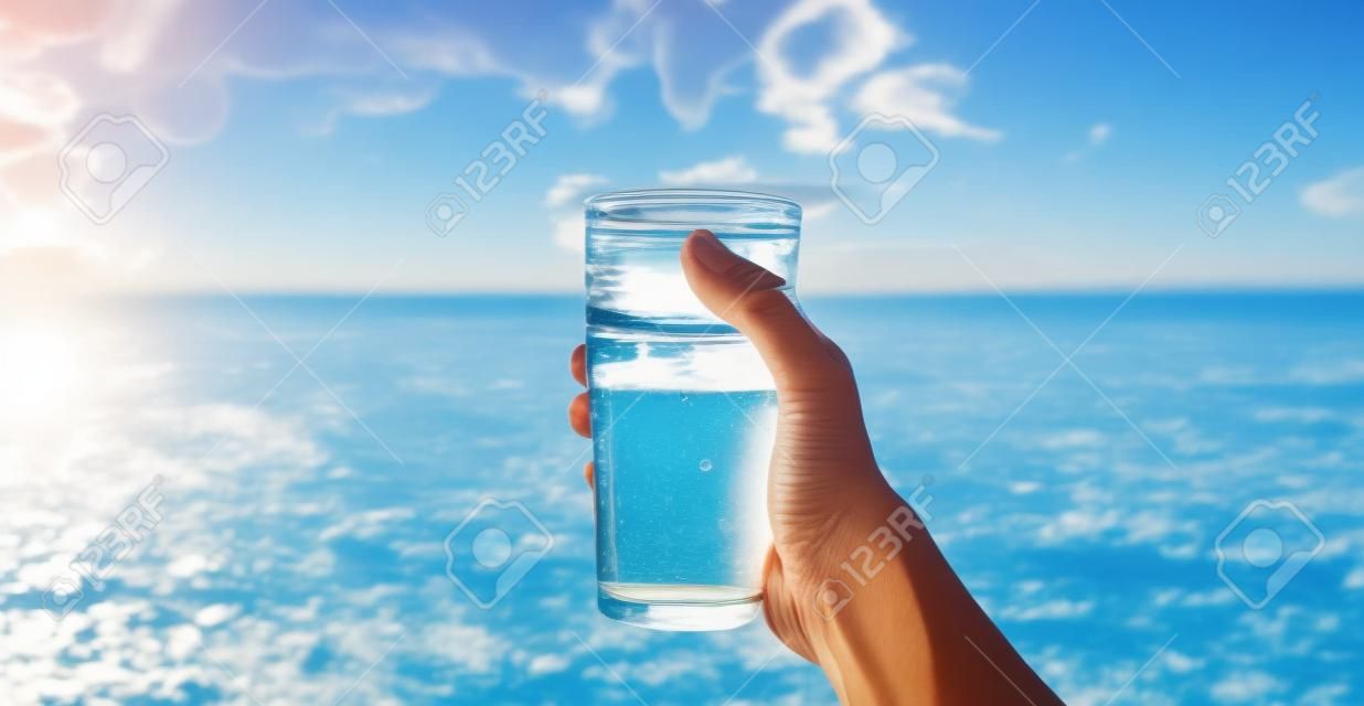 Woman's hand holds a glass of water, health and nutrition concept