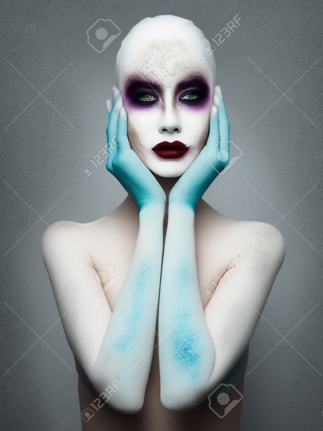 Body art nude woman. conceptual halloween make-up. painted white powder skin beauty girl