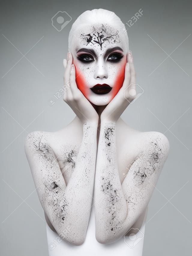 Body art nude woman. conceptual halloween make-up. painted white powder skin beauty girl