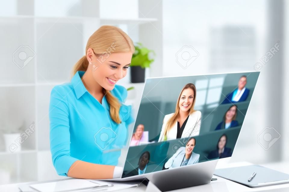 Businesswomen happy using high technology online meeting via internet with futuristic digital device to video calling with business partner around the world in the office concept.