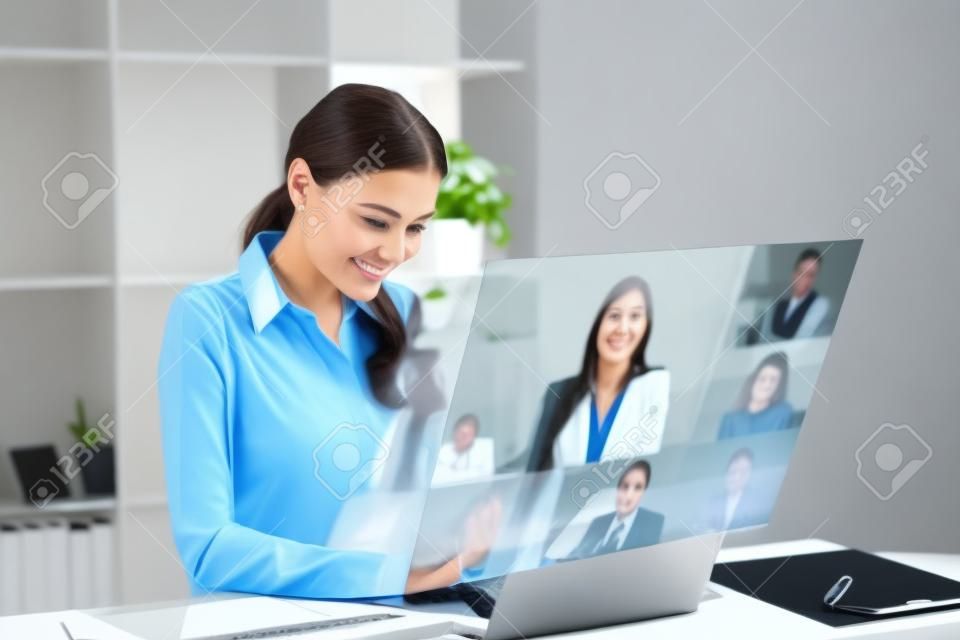 Businesswomen happy using high technology online meeting via internet with futuristic digital device to video calling with business partner around the world in the office concept.