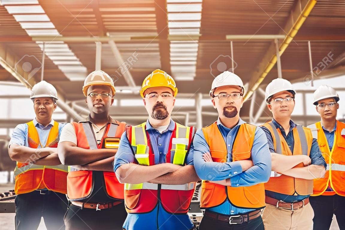 Group of Worker Engineer Teamwork people mix race in Heavy Industry standing confident.selective focus at center man