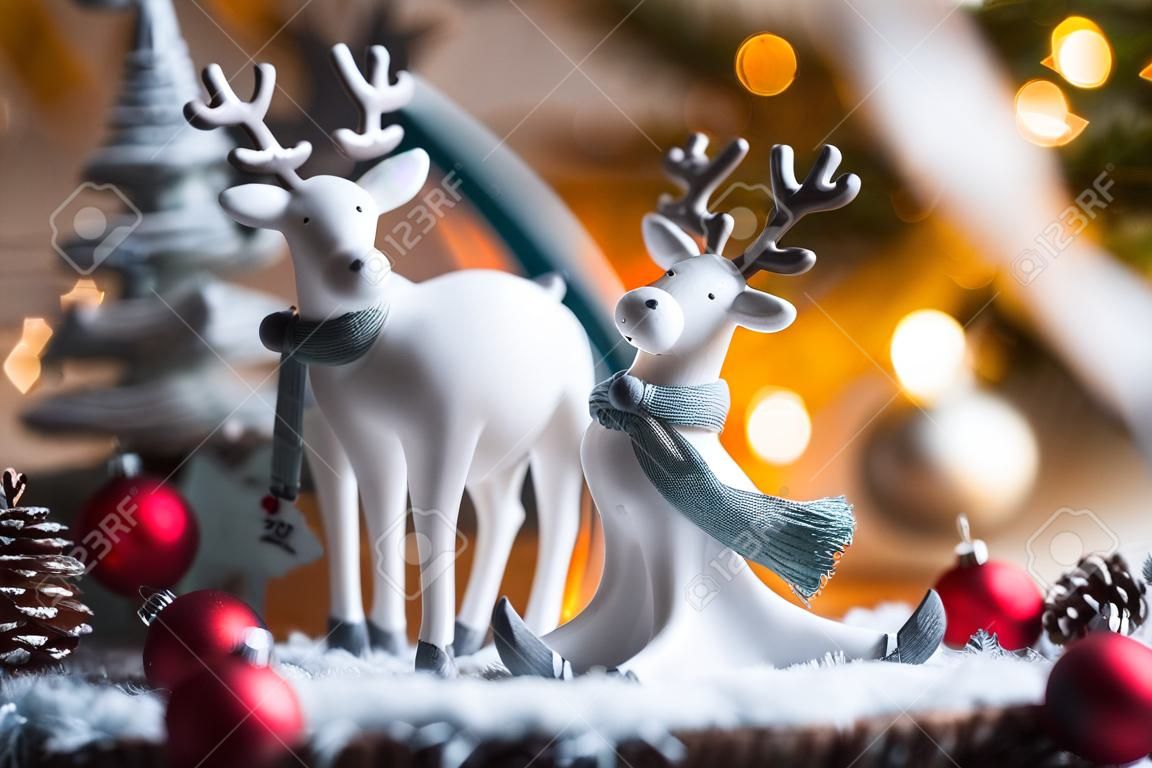 Happy New Year 2023. Christmas card with cute reindeer on a beautiful bokeh background. New Year's still life. The concept of a home holiday, warmth and comfort.