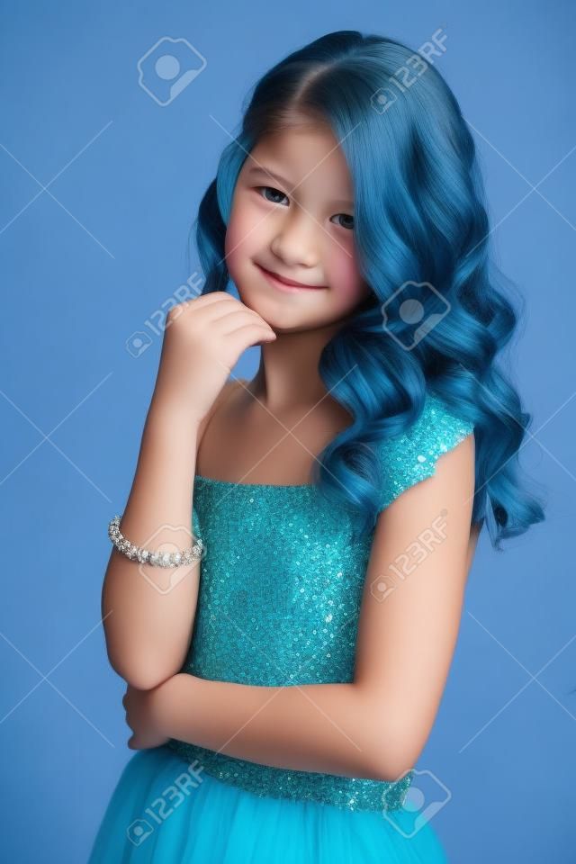 Pre-teen girl with beautiful hair in blue dress.