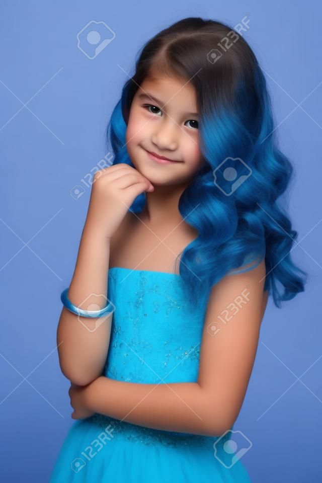 Pre-teen girl with beautiful hair in blue dress.